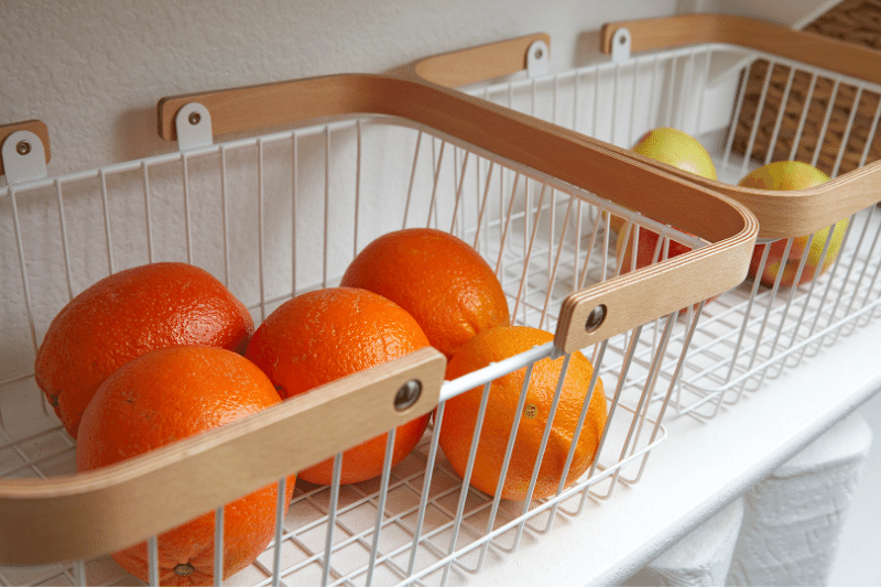 organize fruit in baskets in pantry